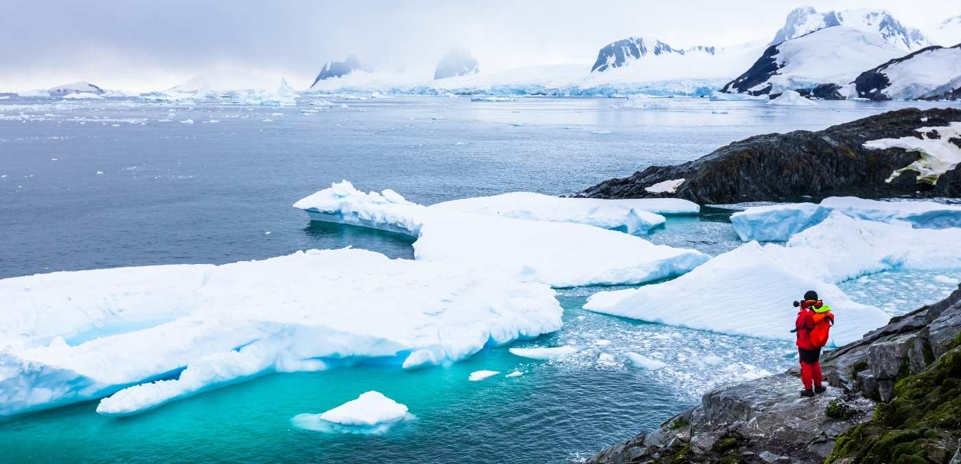 photographer taking photos of antarctic coastline