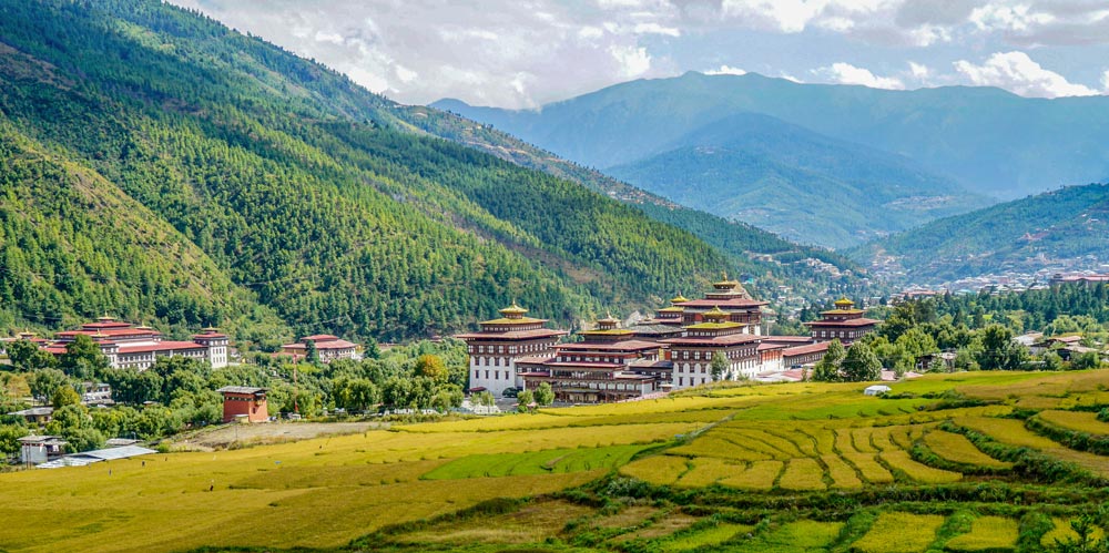 Bhutan, Tashichho Dzong in Thimphu. Surrounded by yellow rice fields, River and mountains