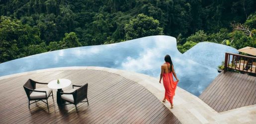 woman walking alongside a pool