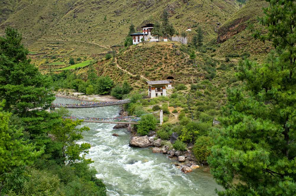 Temple sitting on mountainside above Paro Chhu River; Bhutan