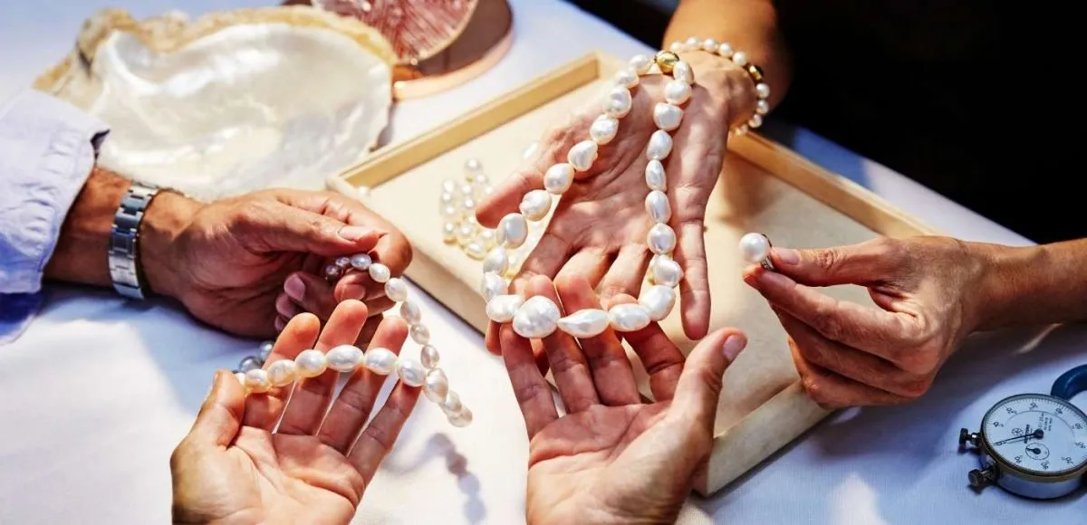 Hands holding string of pearls at Cygnet Bay Pearl Farm, Dampier Peninsula_Tourism WA