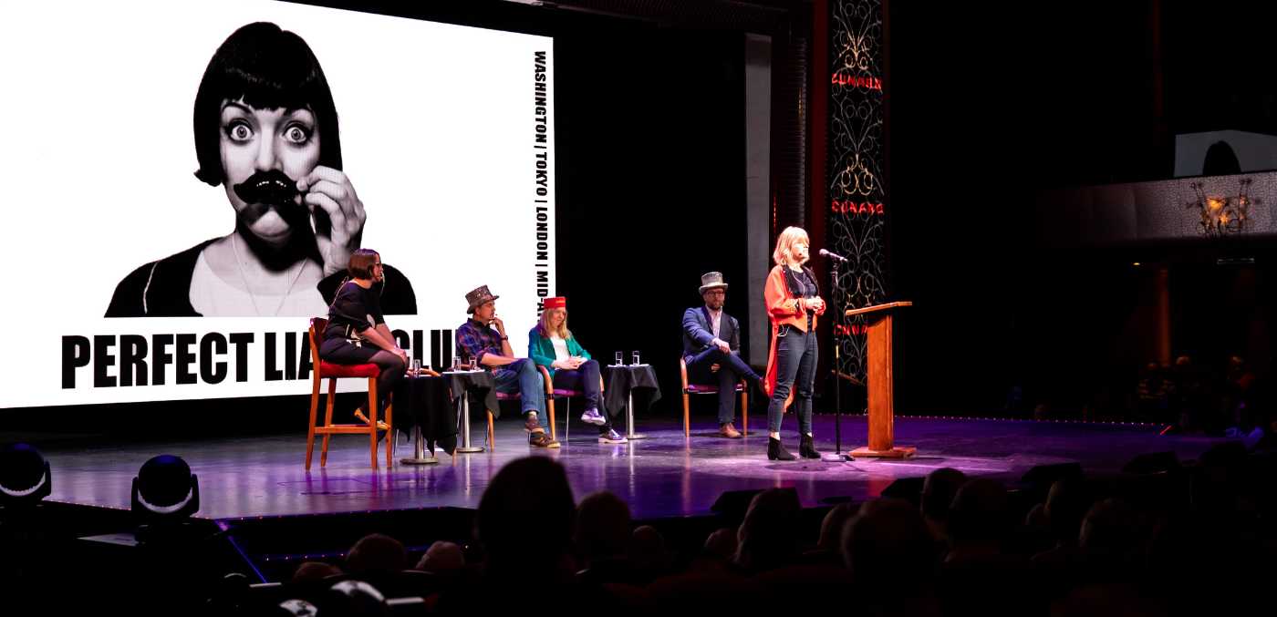 people standing on a stage giving a presentation