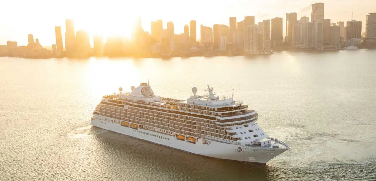 Seven Seas Splendor in front of city skyline