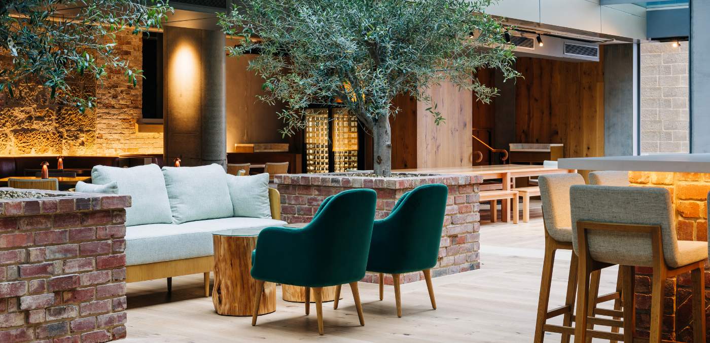 green armchairs and a green and gold sofa in a restaurant